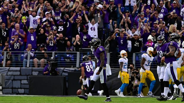 Lamar Jackson and Ravens fan celebrate a touchdown against the Chargers